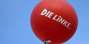 Ein roter Luftballon mit der Aufschrift "Die Linke" steigt in den blauen Himmel