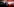 Der sozialistische Kandidat neben einer roten Wand, im Hintergrund Fotografen. Er hält sich die Hand vor den Mund