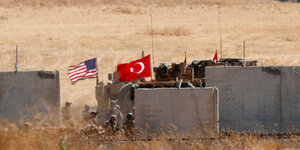 Türkische und amerikanische Flagge, Panzer hinter Betonwällen