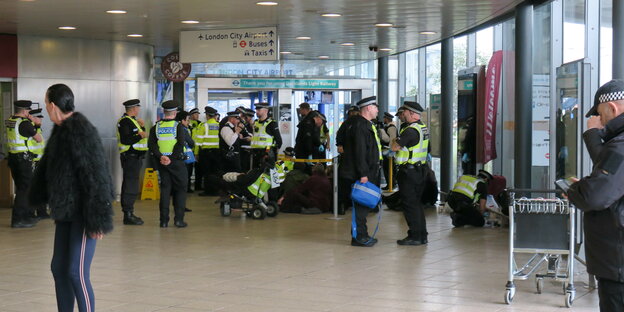 Der London City Airport. Am Flughafen stehen vielePolizeibeamte.
