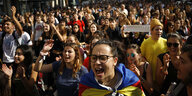 Mehrere Menscen marschieren mit Plakaten der inhaftierten Unabhängigkeitspolitiker durch Barcelona, eine Frau bläst in eine Trillerpfeife