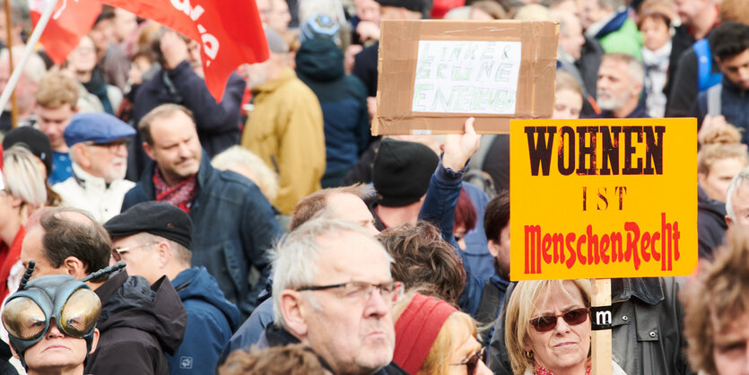 Mneschen demonstrieren mit Plakaten