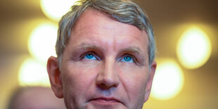 Mann mit blauen Augen sieht nach oben. Es ist Björn Höcke