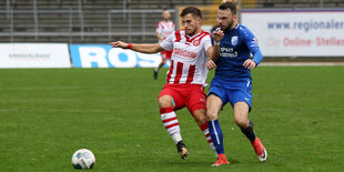 Zweikampf um den Ball im leeren Stadion