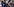Brasiliens Ex-Präsident Lula steht inmitten von Menschen und streckt den Arm in die Luft.