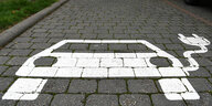 Brandenburg, Grünheide: Eine Markierung auf dem Boden auf dem Marktplatz weist auf einen Parkplatz und Ladestation für Elektroautos