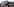 Mann sthet mit deiner Fahne vor dem ehemaligen Konzentraitonslager Buchenwald