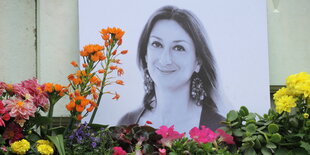 Kerzen und Blumen stehen im Gedenken vor einem Foto der ermordeten maltesischen Journalistin Daphne Caruana Galizia vor dem Justizpalast.