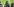 Aminata Touré spricht in ein Mikrofon, links und rechts von ihr lauschen ihr Männer