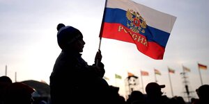 Silhouette eines Jungen, der die russische Fahne trägt