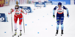 zwei Skilangläuferinnen von verschiedenen Teams auf einem Turnier auf dem Schnee