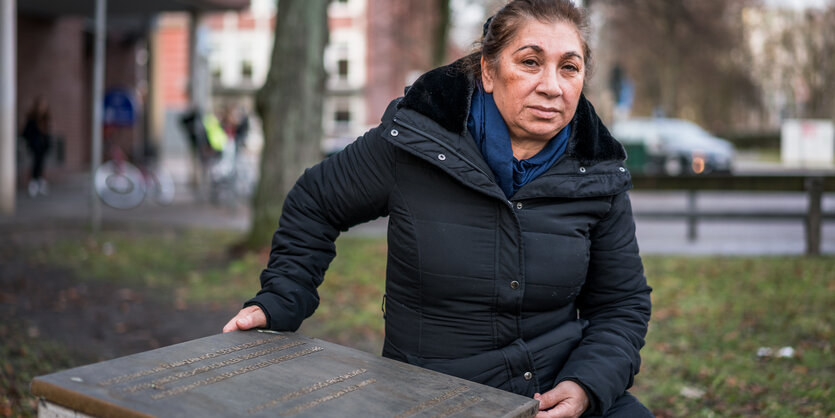 Gülüstan Avcı kniet neben der Gedenktafel für ihren getöteten Verlobten