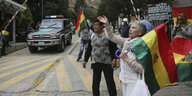 Am Eingang zur Residenz des mexikanischen Botschafters protestieren Menschen mit Nationalfahnen Boliviens