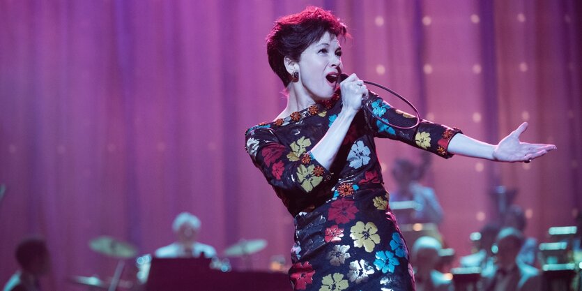 Renée Zellweger als Judy Garland singt groß im Bild. Im Hintergrund ist die Big Band zu erahnen