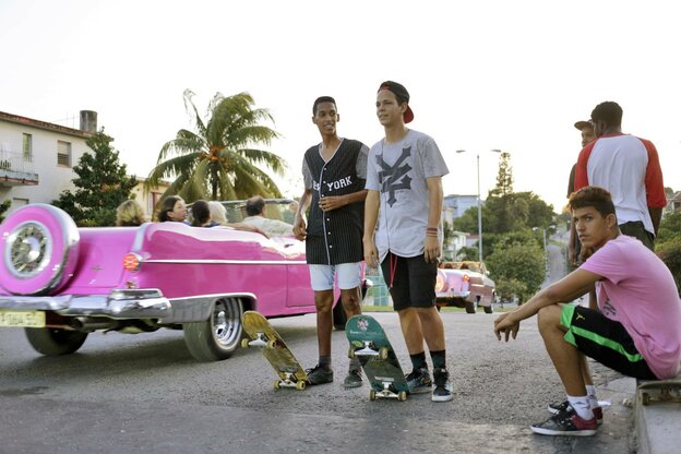 Pinkfarbene Oldtimer und Jungen mit Skatboards