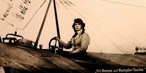 Frau im Cockpit eines alten Flugzeugs