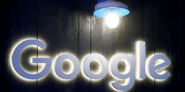 eine Lamppe beleuchtet das Google-Logo