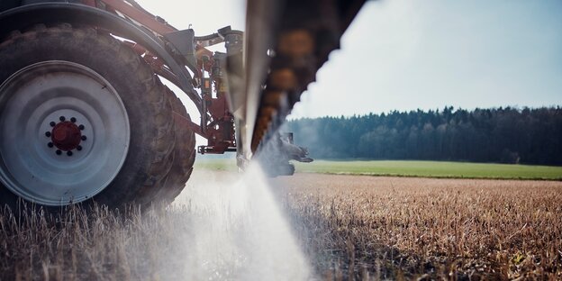 Ein Traktor fährt bei Göttingen über ein Feld und bringt mittels einer gezogenen Anhängespritze Glyphosat aus