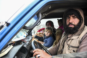 Eine Familie in ihrem Auto bei der Flucht aus Idlib