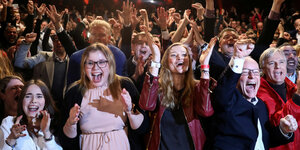 Sozialdemokratinnen feiern mit erhobenen Händen und lachend