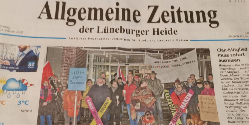 Menschen protestieren mit Plakaten und Kerzen