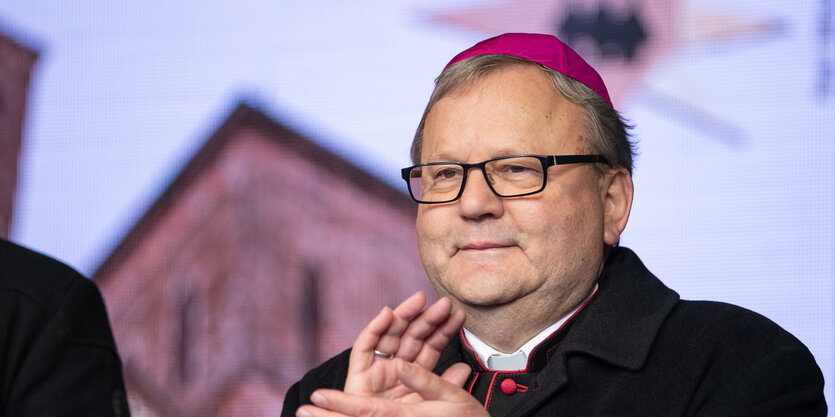 Bischof Franz-Josef Bode applaudiert den Sternsingern.