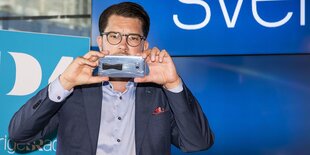 Ein Mann mit Smartphone filmt zurück