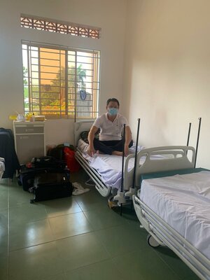 Mann mit Mundschutz in einem Krankenzimmer.