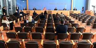 ein Raum mit vielen leeren Stühlen vor einem Podium