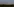 Hinter einer Hecke sieht man die Skyline von Mailand