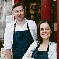 Ein Mann und eine Frau in weißen Hemden mit Schürzen