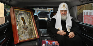 Der Patriarch Kirill mit der heiligen Ikone auf dem Rücksitz eines Autos