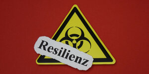 Ein Biohazard-Zeichen und das gedruckte Wort "Resilienz"