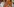 Kishori Pednekar sitzt auf einem orangfarbenen Samstuhl in einer orangfarbenen Robe