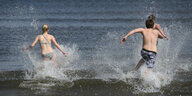 Zwei Jugendliche stürmen ins Meer