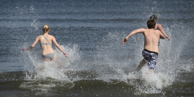 Zwei Jugendliche stürmen ins Meer