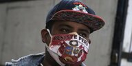 Ein Mann mit einer Maske, auf der Resist Peru steht