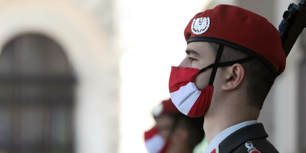 Soldat mit Gesichtsmaske in rot-weiß-rot