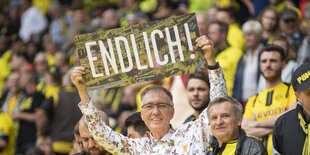 Fan hält Schild mit Aufschrift "Endlich" hoch