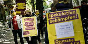 menschen stehen mit Plakaten bei einem Protest