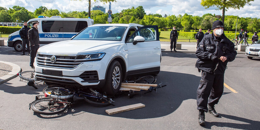 Ein SUV fährt bei einer Protestaktion über Fahrräder