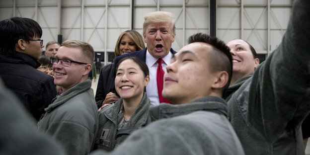Trump und Soldaten mit Handy
