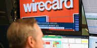 Auf dem Fernsehmonitor eines Aktienhändlers auf dem Parkett der Frankfurter Wertpapierbörse läuft die Nachricht, dass sich der Betrugsverdacht bei Bezahldienstleister Wirecard erhärtet.