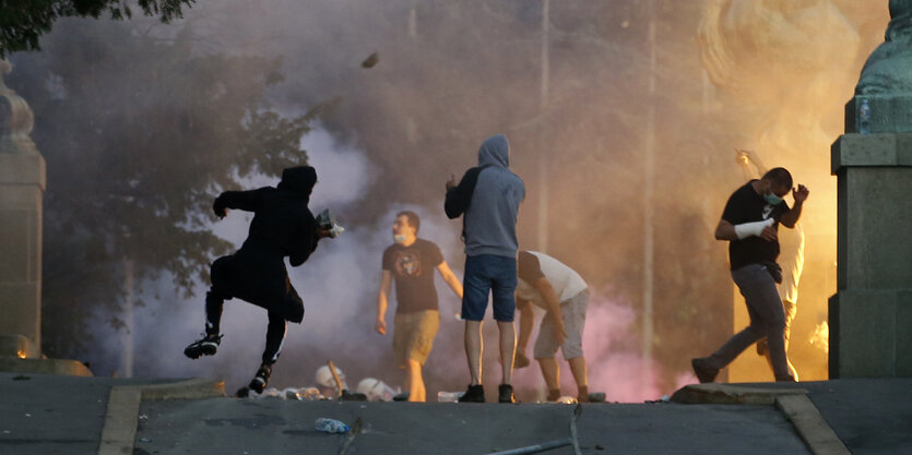 Protestierende auf den Straßen werfen mit Gegenständen.