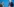 Zwei Männer stehen sich vor einem blauem Hintergrund gegenüber und halten den Verfassungsschutzbericht in den Händen.