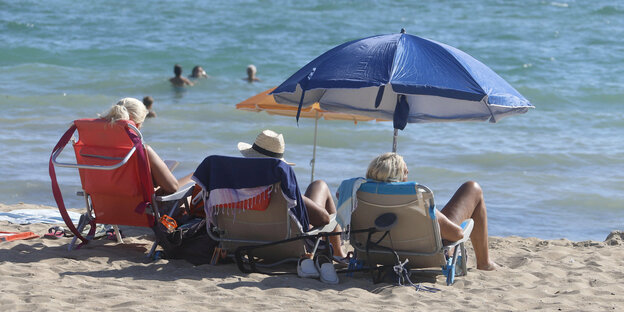 Menschen genießen die Sonne am Strand von El Arenal.