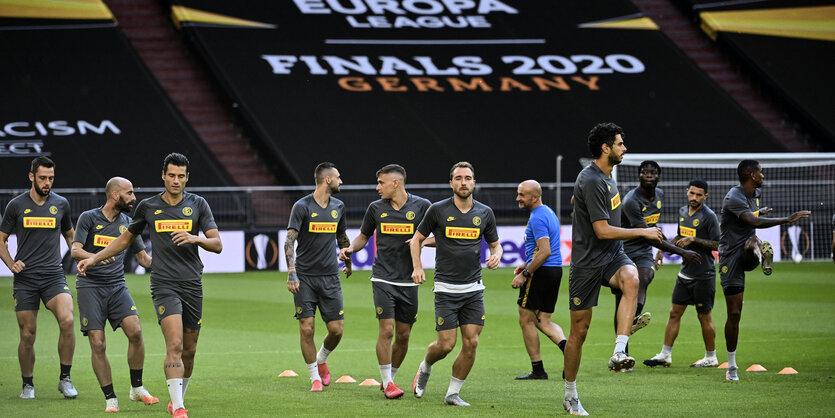 Fußballteam im leeren Stadion beim Aufwärmen