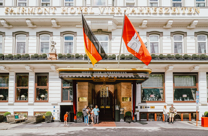 Eingang mit weit überkragendem Dach und einer Deutschland sowie einer Hamburg-Fahne