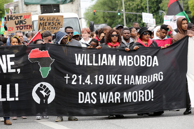 Menschen bei Protestkundgebung mit einem Banner in der Hand Menschen bei Protestkundgebung mit einem Banner in der Hand