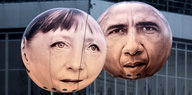 Ballons mit den Gesichtern von Barack Obama und Angela Merkel